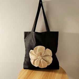 Elegant Black Tote Bag with Cream Floral Accent
